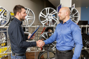 male customer and salesman shaking hands at car repair service or auto store. AutoFix Auto Shop Coaching