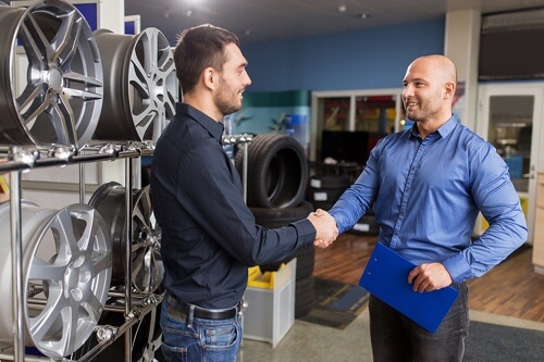 AutoFix Auto Shop Coaching Program; Auto coach and Auto shop owner shaking hands at auto shop