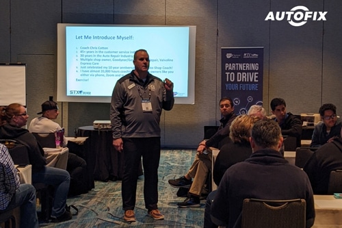Chris Coton talking to an audience of auto repair shop owners. Concept image of “What Makes AutoFix Auto Shop Coaching Truly Unique” | AutoFix Auto Shop Coaching.