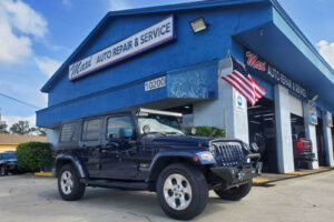 Accelerating Success | Expert Growth Strategies for Auto Repair Shops - AutoFix Coaching. Image of blue jeep wrangler parked outside of Maxi Auto Repair Shop.