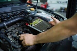 Digital Vehicle Inspection in Use at AutoFix Auto Shop Coaching. Image of a mechanic using a tablet to conduct an engine diagnostic in a car, demonstrating AutoFix Auto Shop Coaching's commitment to advanced vehicle inspection technologies for improved service accuracy and efficiency.