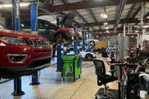 Auto repair shop coaching at AutoFix Auto Shop Coaching. Image of multiple vehicles on lifts undergoing expert diagnostics, maintenance, and repair. Image showcases a modern service facility equipped to service domestic, European, and import vehicles.