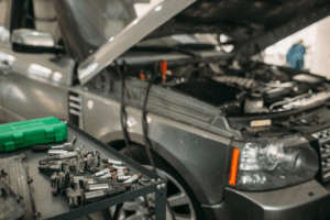 Diesel repair shop, auto shop coaching at AutoFix Auto Shop Coaching. Image shows a luxury SUV undergoing professional engine diagnostics and ignition system repair at an auto repair shop.
